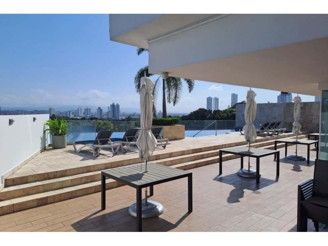 Infinity style swimming pool on terrace with lounge chairs and skyline view PH Tee One Panama