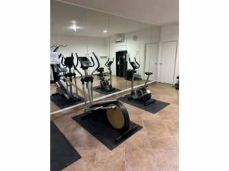 Outdoor gathering lounge with hammocks palm trees near beach PH Ibiza Playa Corona Panama