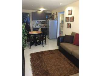 Living dining area with open kitchen and balcony Playa Corona beachfront property Panama