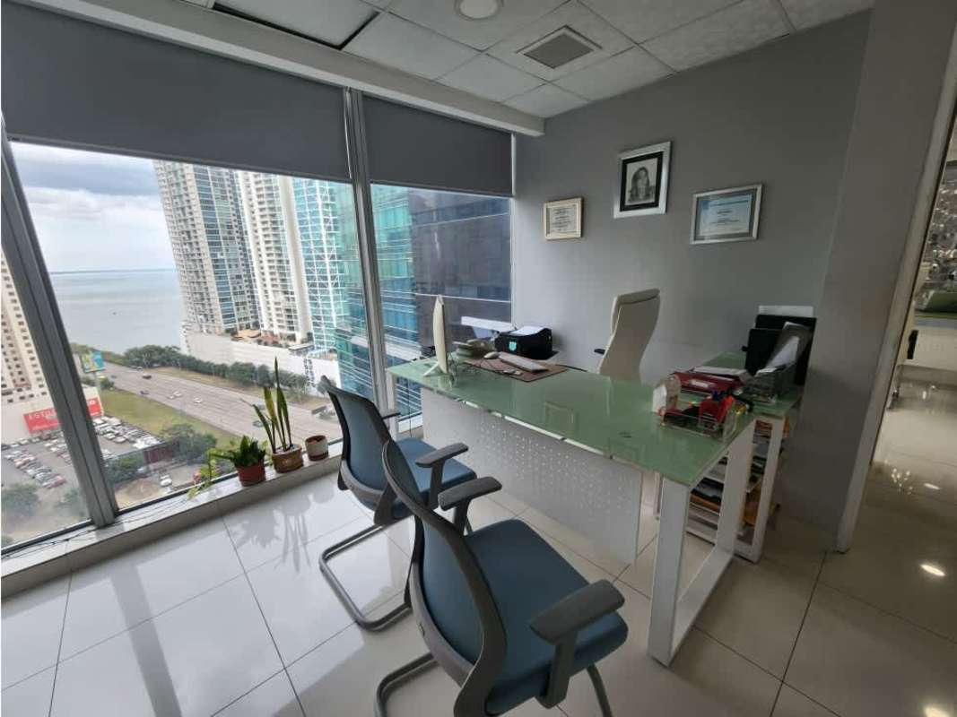 Private office with floor-to-ceiling glass window overlooking Pacific Ocean and Panama skyline Oceania Business Plaza