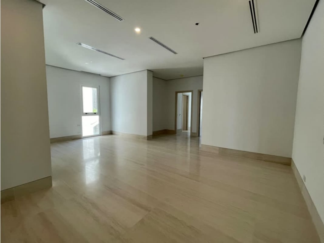 Spacious minimalist living room with floor-to-ceiling glass, ocean and skyline views at Ocean Reef Islands