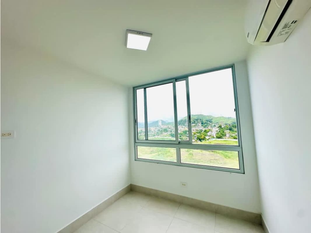 Bedroom featuring large window, split AC and built-in closet with mountain views Greenwood Towers Panama