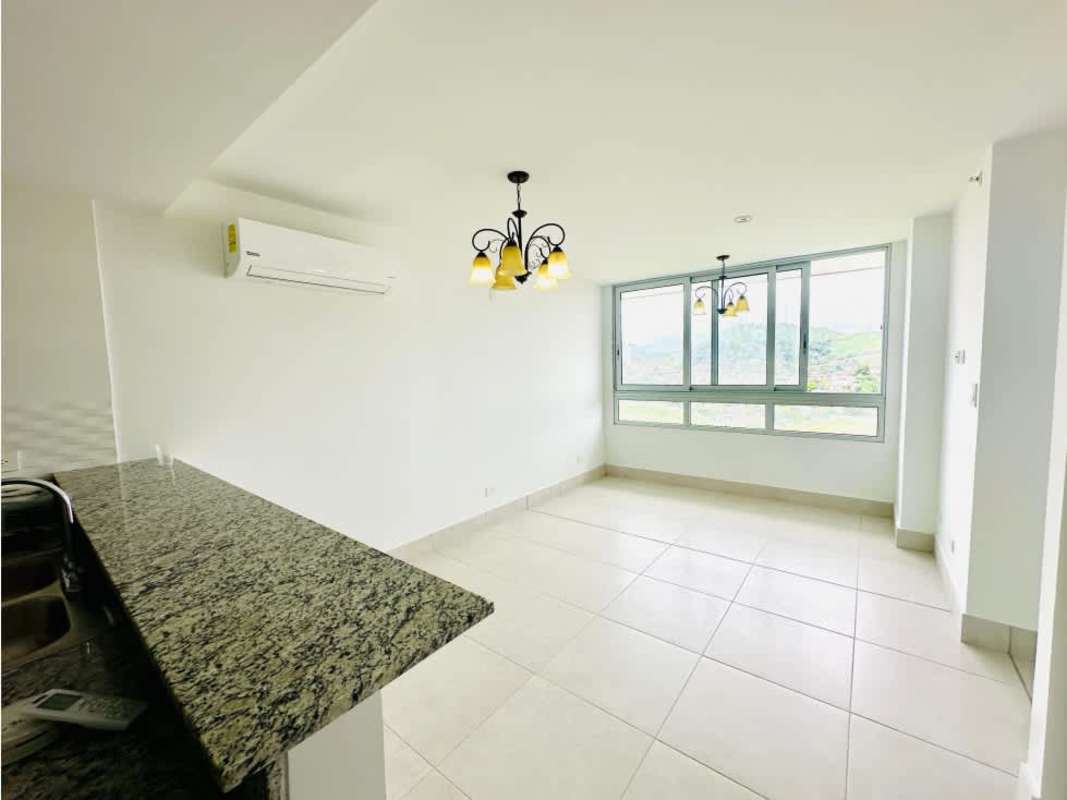 Living room with large window, AC unit and granite kitchen bar Greenwood Towers Panama City