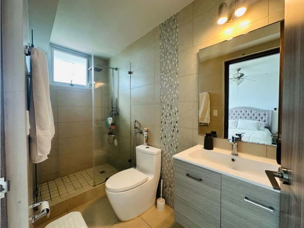 Elegant bathroom with vanity, large mirror and glass enclosed shower in PH Lumiere Costa del Este Panama