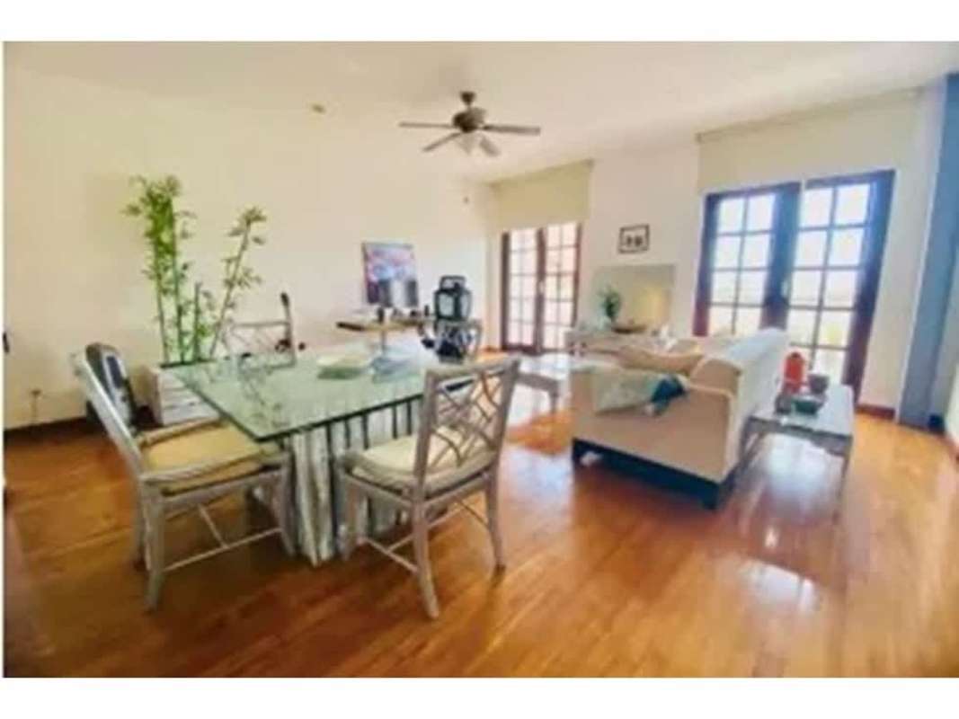 Spacious open-concept living dining area with wood floors, natural light in PH Star & Herald