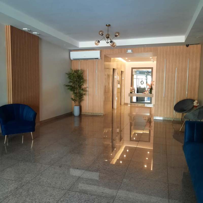 Elegant lobby with polished tile floors, wood accents, stylish furniture in PH Aquazul Bella Vista Panama City
