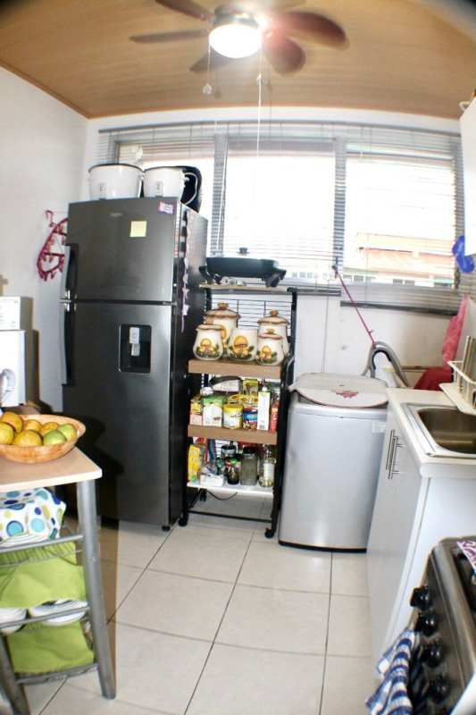 Functional kitchen with stove, fridge, fan and laundry in Llano Bonito Panama