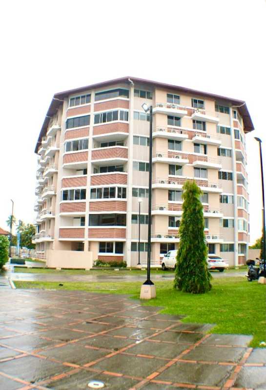 Modern mid-rise apartment buildings with balconies at Llano Bonito Gardens