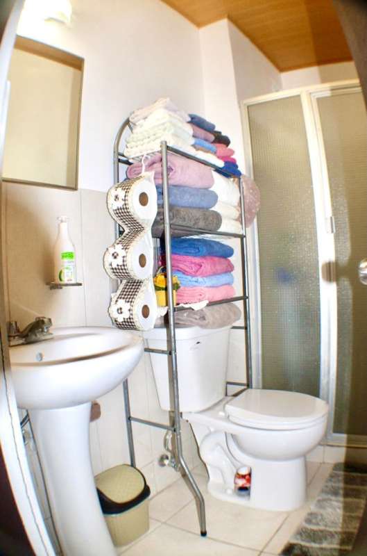 Contemporary bathroom with pedestal sink, tiled walls and shower in Llano Bonito Gardens Panama