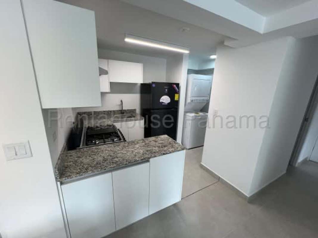 Compact modern kitchen with granite counters washer dryer fridge at PH Marea Plaza Panama