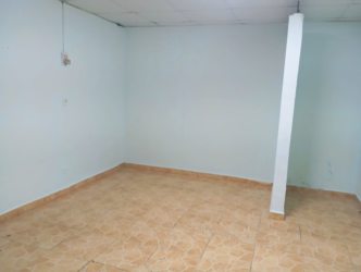 Spacious empty living and dining room with light blue walls and ceramic tile in house Lluvia de Oro 2 Arraiján Panama