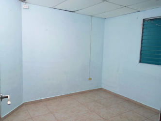 Narrow kitchen space with brown cabinetry, double sink, and tiled backsplash in house at Lluvia de Oro 2 Panama