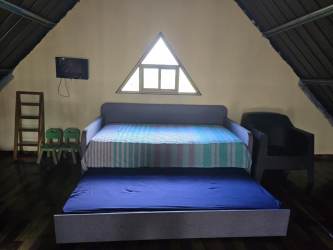 Spiral staircase connecting to upper loft with mountain views in Volcancito Boquete Panama rental cabin