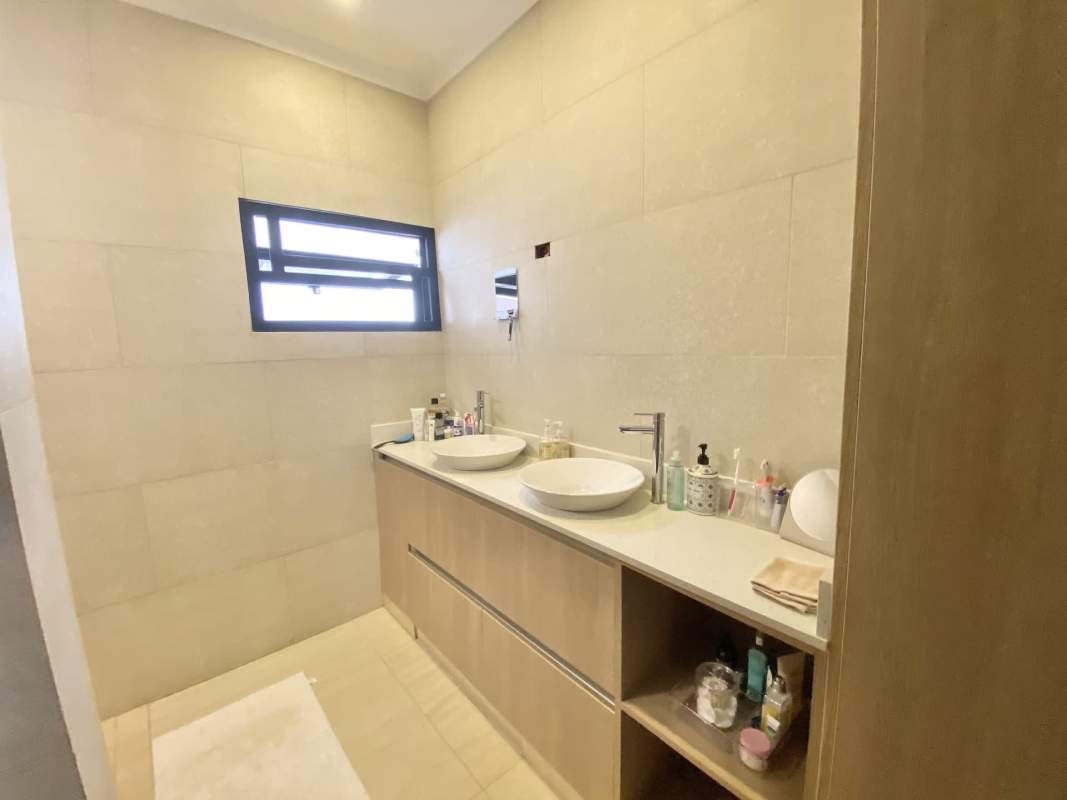 Bright children's room with large window, mint green walls, crib and twin bed El Dorado Panama