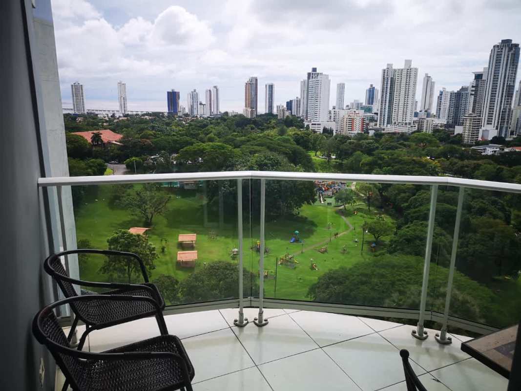 Spacious balcony with panoramic park and skyline views, glass railing PH Parque Central Carrasquilla Panama