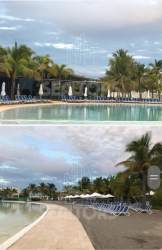 Giant seawater pool with tropical landscaping at Playa Blanca beachfront condominium resort Panama