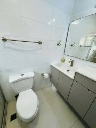 Covered terrace with fans and green garden perfect for kids and barbecues in rental house Panama Pacifico