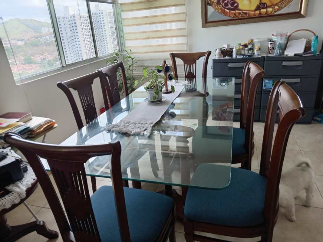 Dining room with glass-top table, panoramic windows, city views, PH Riverside Condado del Rey Panama