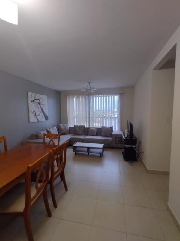 Contemporary living room and dining with large windows and tile flooring PH Torres de Versalles Panama