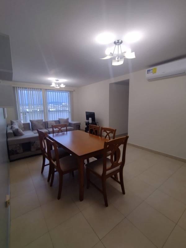 Dining room with wooden table and six chairs, tile floor, decor in Torres de Versalles