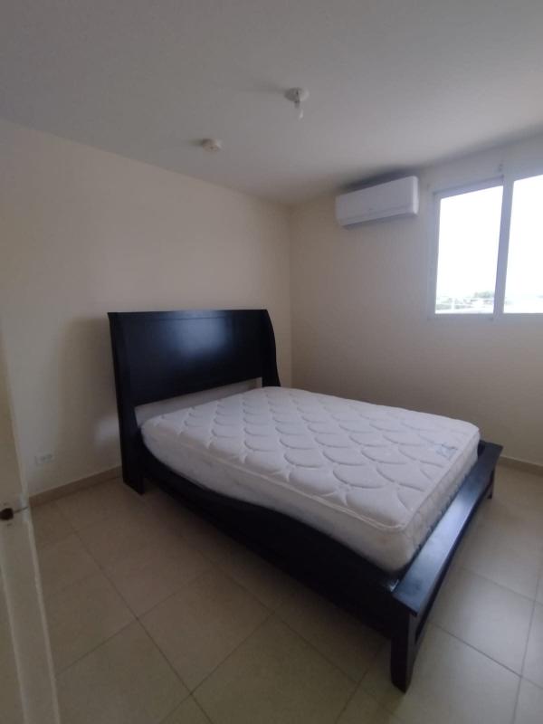 Bedroom with black bed, AC, tile floor, window in Torres de Versalles Panama