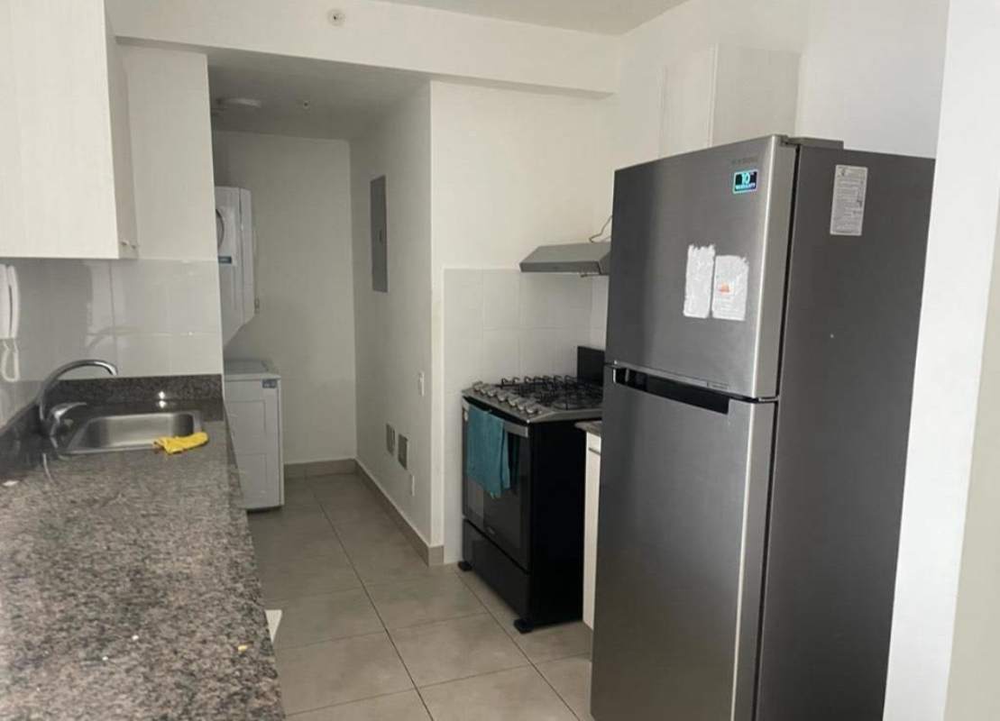 Modern apartment kitchen with granite counters and laundry area PH Gaudí Panama