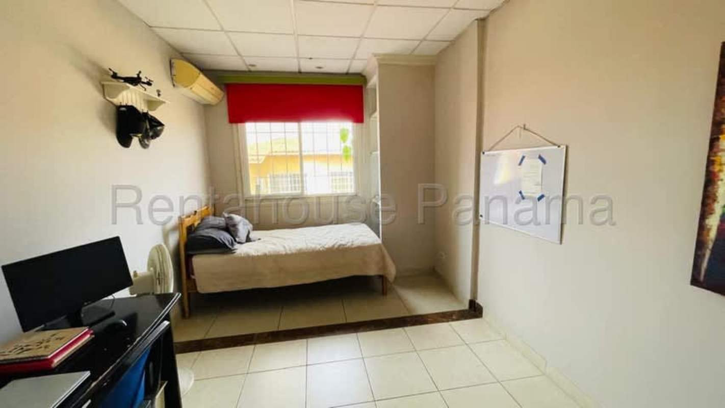 Outdoor patio with pergola, lush plants, and BBQ area in townhouse rental Condado del Rey