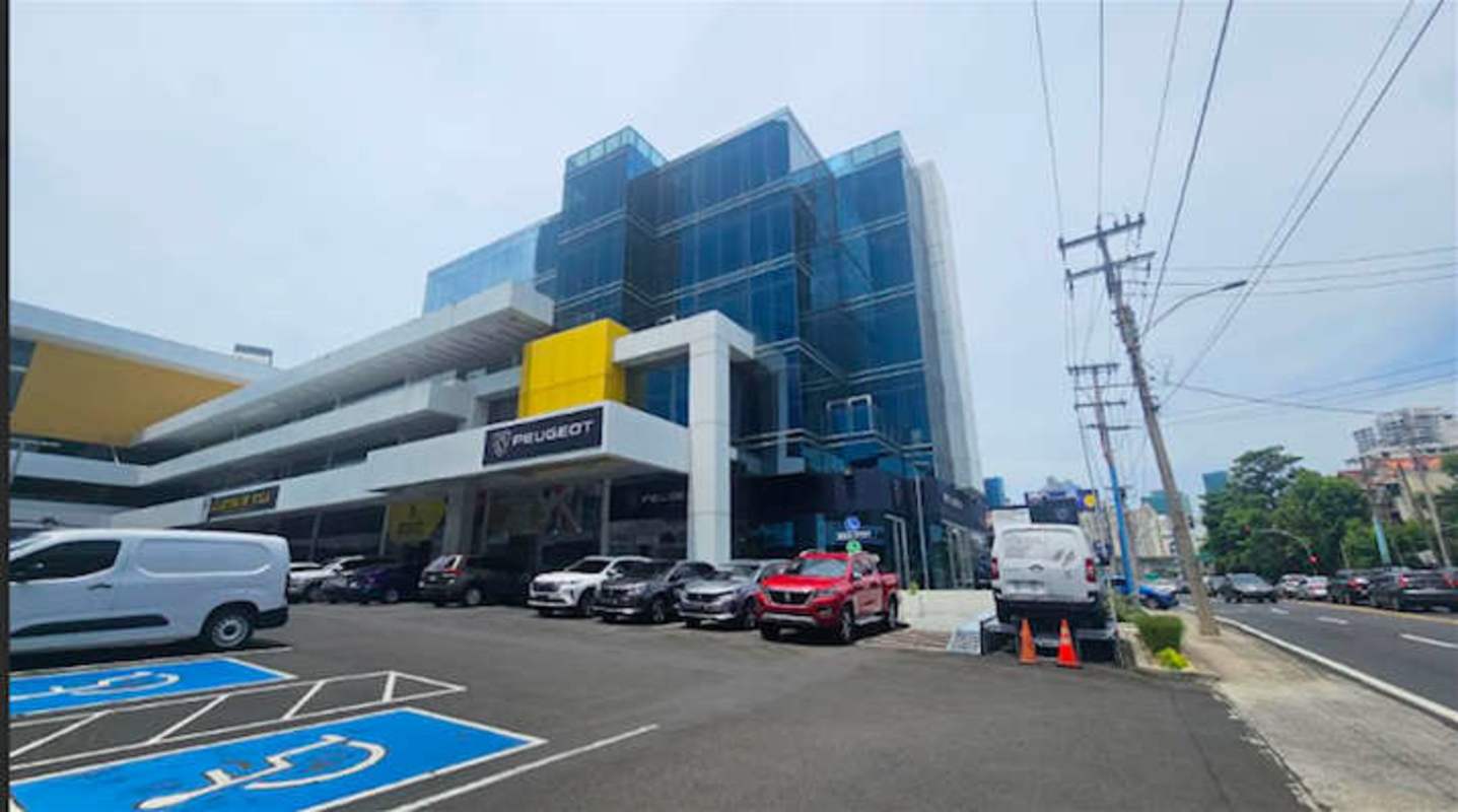 Modern commercial property with glass facade, dealership signage and ample parking City Mall Via Brasil Panama City