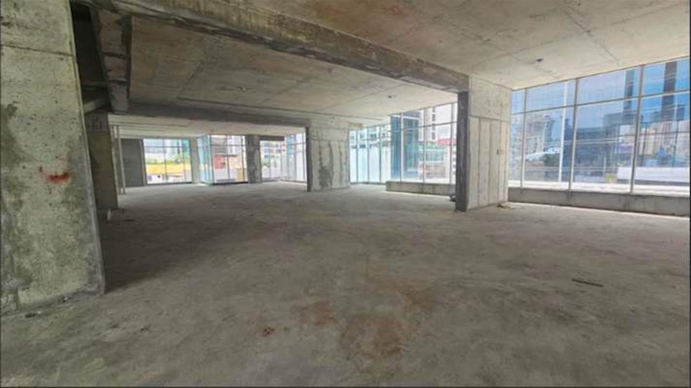 Large open-plan unfinished commercial interior with floor-to-ceiling windows at City Mall Via Brasil