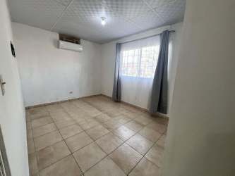 Spacious living room with tiled floors and large windows in rental house Residencial San Pablo David Panama