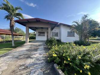 Equipped kitchen rental house with brown cabinets and window to garden San Pablo David Panama