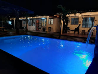 Bedroom with double bed, bunk bed, blue curtains, air conditioning at Malibu cabins Gorgona Panama