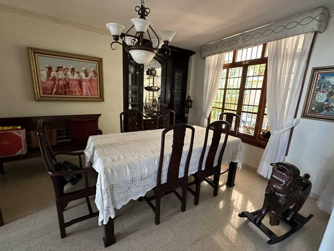 Interior staircase with ceramic tiles, wood banister, decorative ironwork Villa de las Fuentes Panama