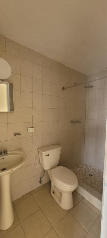 Minimalist bathroom with beige tiles, pedestal sink and walk-in shower in PH Casa Real San Francisco Panama
