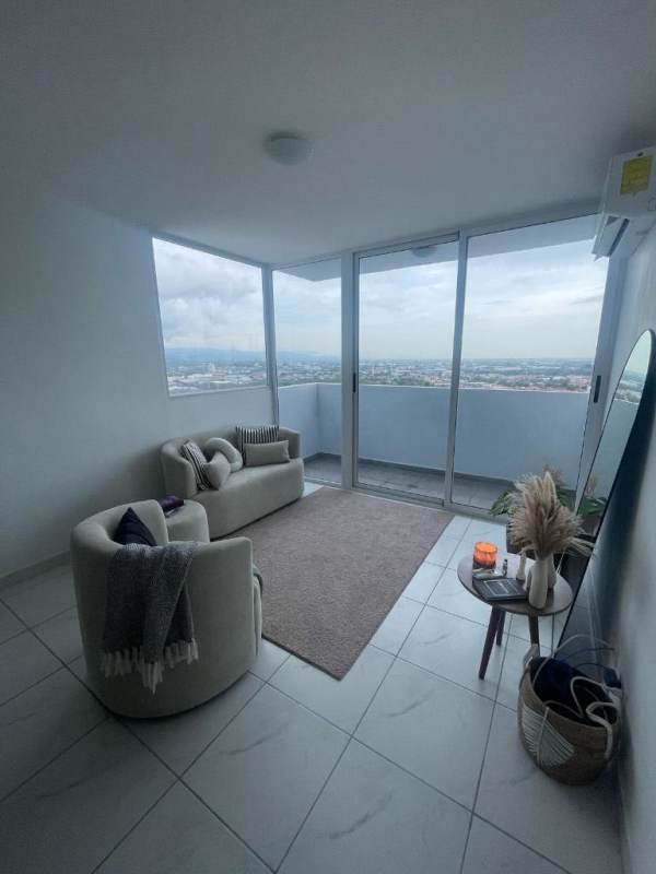 Modern living room with floor-to-ceiling windows and balcony PH Millenials Panama City