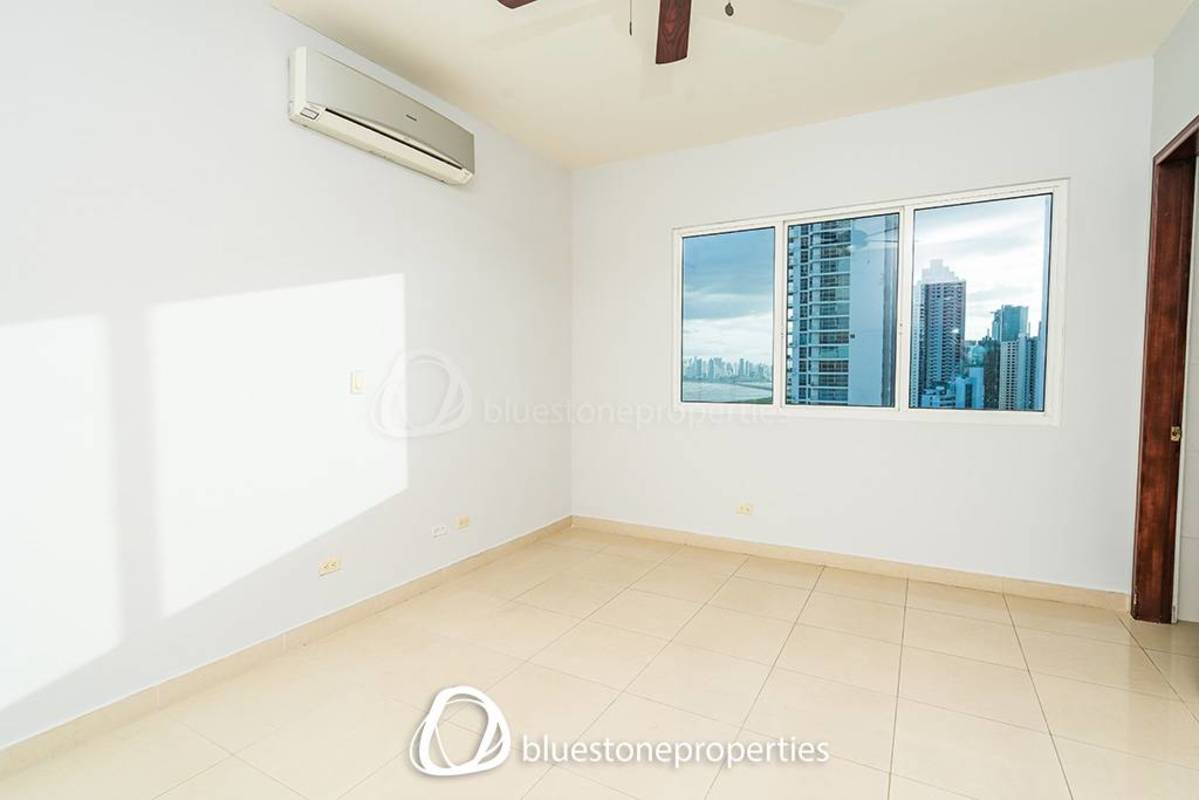 Luxury apartment living room with marble floors, floor-to-ceiling windows and ocean view in PH Toledo Costa del Este Panama