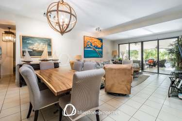 Covered patio with private pool, tropical landscaping, outdoor dining area in Buenaventura beachfront condo Panama