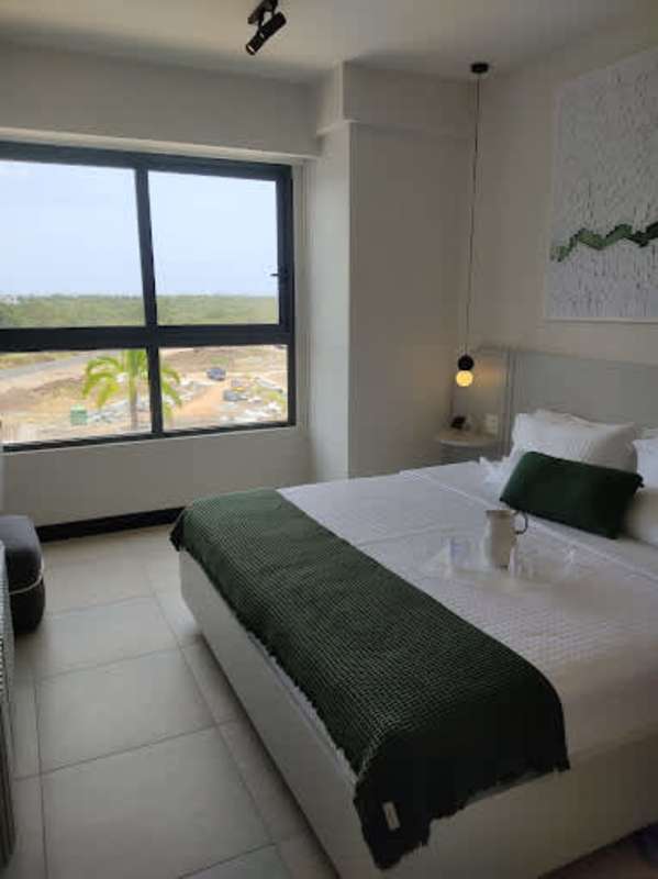Elegant bedroom with large window looking over the golf course in PH Oceana Residences Santa Maria Panama