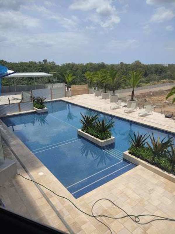Modern swimming pool with sun loungers and landscaping at PH Oceana Residences Santa Maria Panama