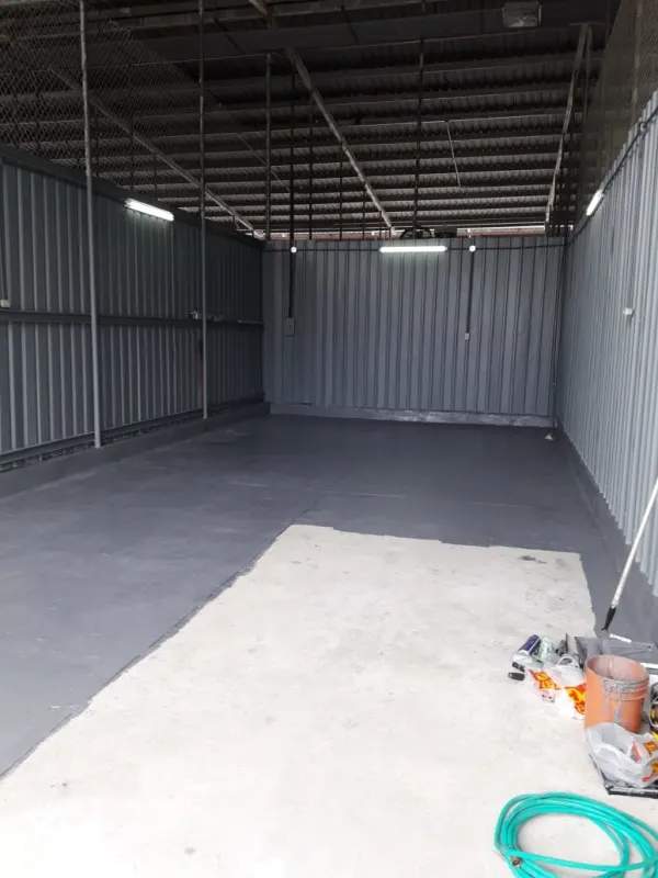 Empty garage with exposed beams, metal siding and concrete polyurethane floor in Diablo Spinning Club