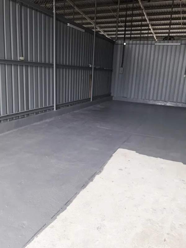 Remodeled garage warehouse with LED lights, metal walls, and concrete flooring in Diablo Spinning Club