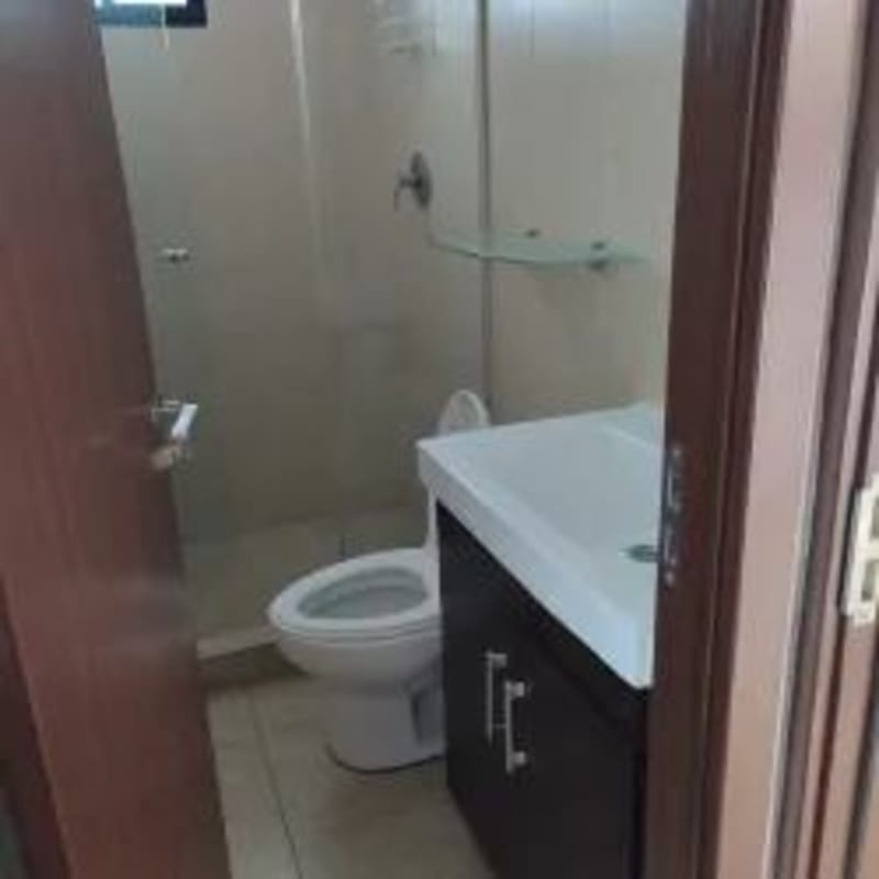 Compact bathroom with glass shower in Panama apartment