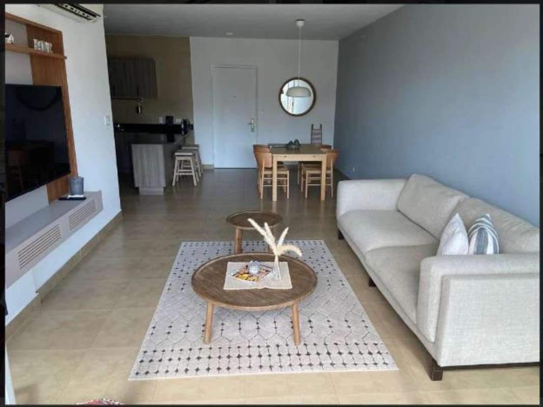 Stylish bathroom with glass-enclosed shower and modern vanity in The One Tower apartment Panama City