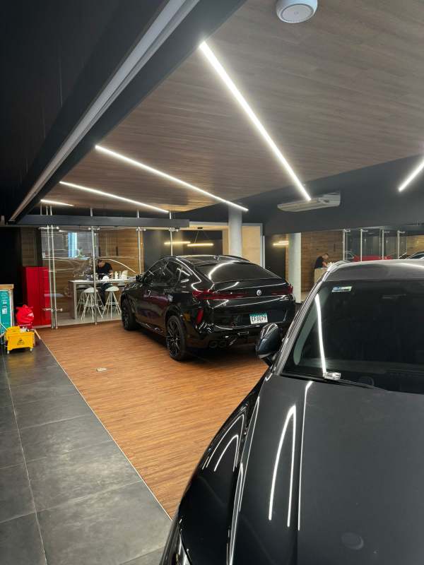 Black and glass modern commercial building facade parking lot Obarrio Calle 50 Panama City