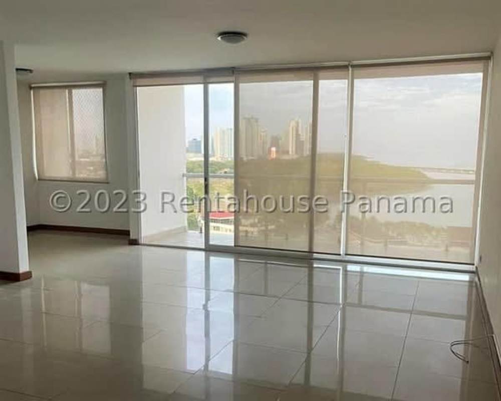 Spacious kitchen with granite countertops, appliances and wood cabinetry at PH Coco del Mar Panama City