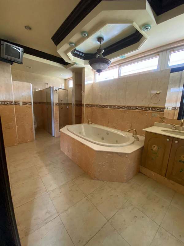 Large master bedroom with four-poster bed, tray ceiling, coffered design in Costa del Este Panama