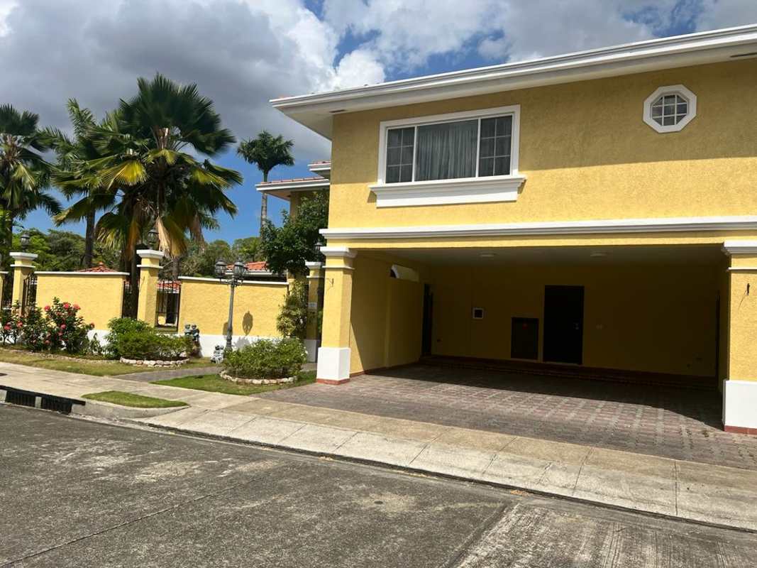 Street side view of yellow house with garage Costa del Este Panama