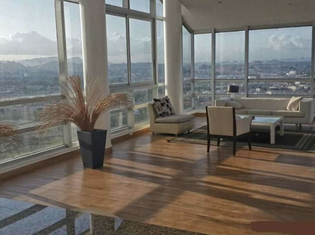 Open living dining space with balcony access natural light furnished apartment Costa del Este Panama