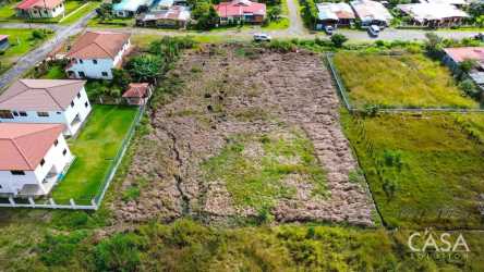 Aerial of flat land parcel with mountain backdrop ready for development