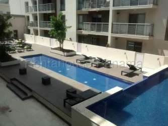 Modern outdoor pool with lounge chairs at PH Mosaic Panama Pacifico residential complex